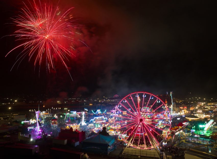 fireworks in the sky above a carnival